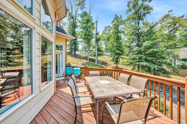 wooden terrace featuring outdoor dining area