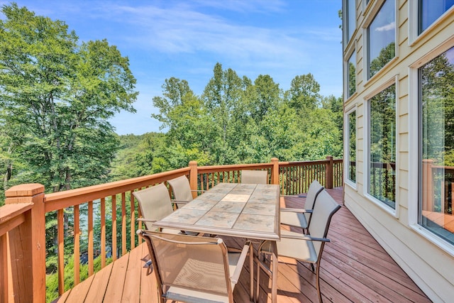 wooden terrace featuring outdoor dining area