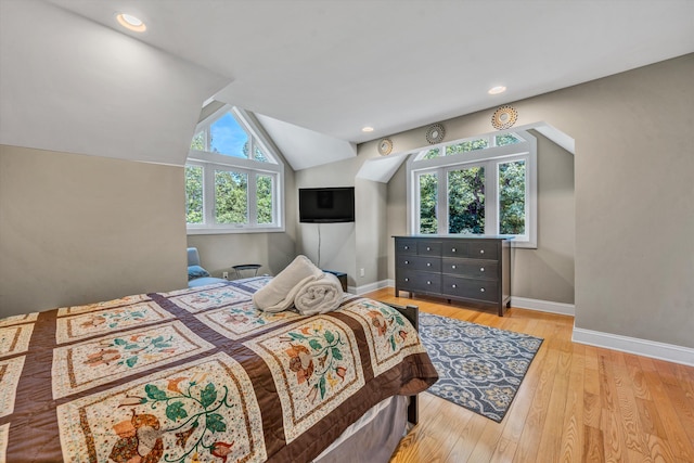 bedroom with lofted ceiling, recessed lighting, wood finished floors, and baseboards