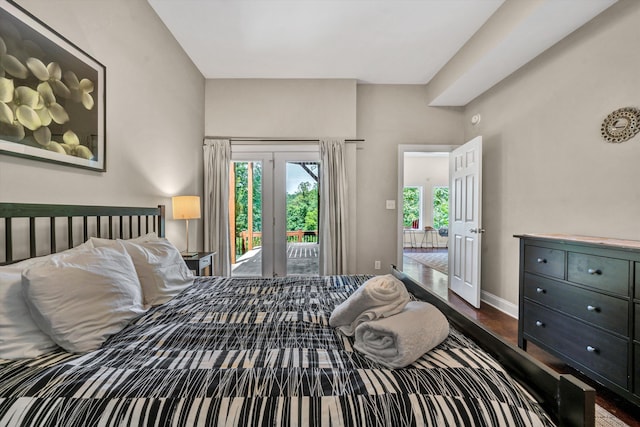 bedroom with access to outside, baseboards, and wood finished floors