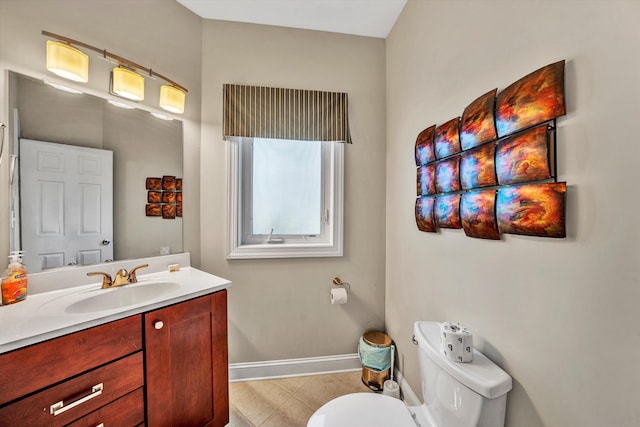 bathroom featuring toilet, tile patterned flooring, baseboards, and vanity