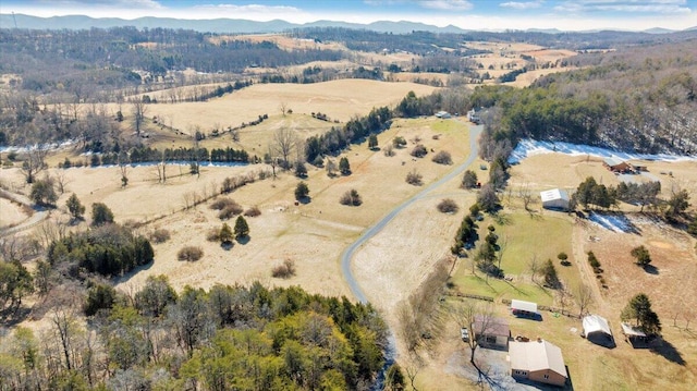 drone / aerial view featuring a mountain view and a rural view