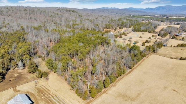 drone / aerial view featuring a mountain view and a wooded view