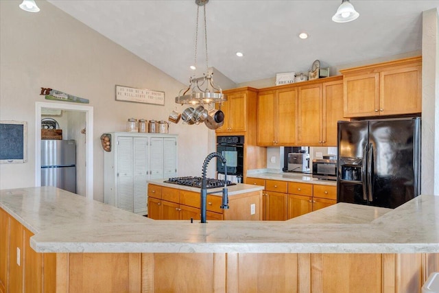 kitchen with lofted ceiling, recessed lighting, hanging light fixtures, a kitchen island with sink, and black appliances