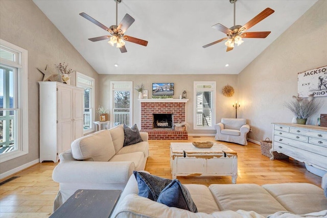 living area with visible vents, light wood finished floors, and a wealth of natural light