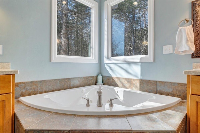 full bath with a garden tub and vanity