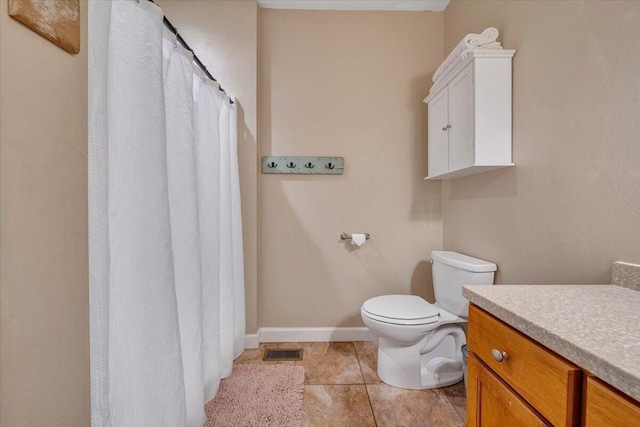 bathroom with baseboards, visible vents, toilet, tile patterned flooring, and vanity