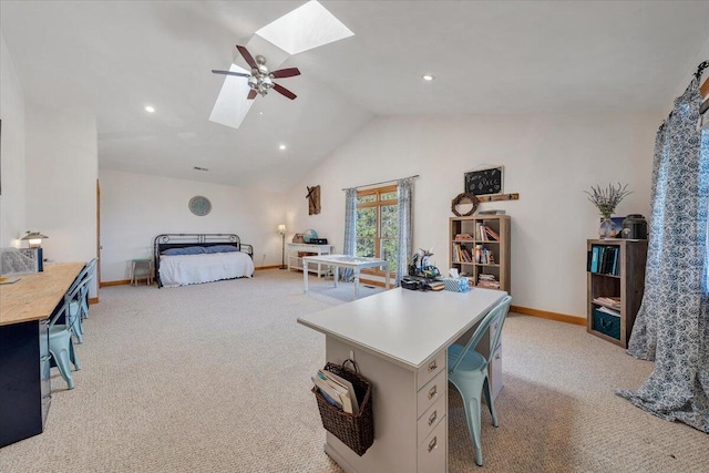 bedroom with light carpet, vaulted ceiling with skylight, a ceiling fan, and baseboards