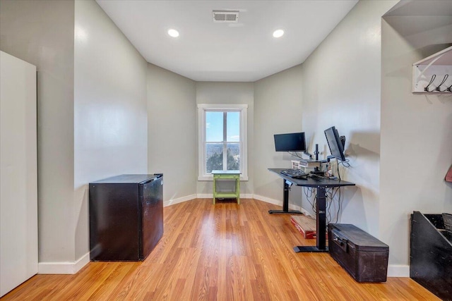 home office featuring light wood finished floors, recessed lighting, and baseboards