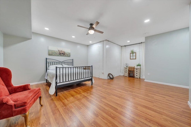 bedroom with light wood finished floors, baseboards, and recessed lighting