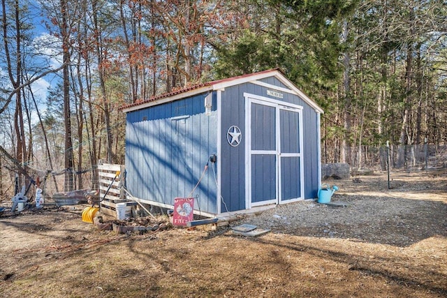 view of shed with fence