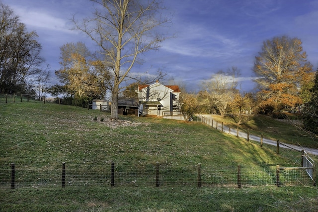 view of yard with a rural view and fence