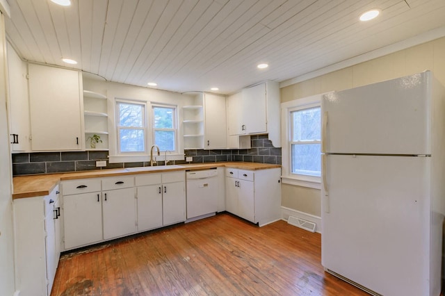 kitchen featuring white appliances, a sink, visible vents, wooden counters, and open shelves