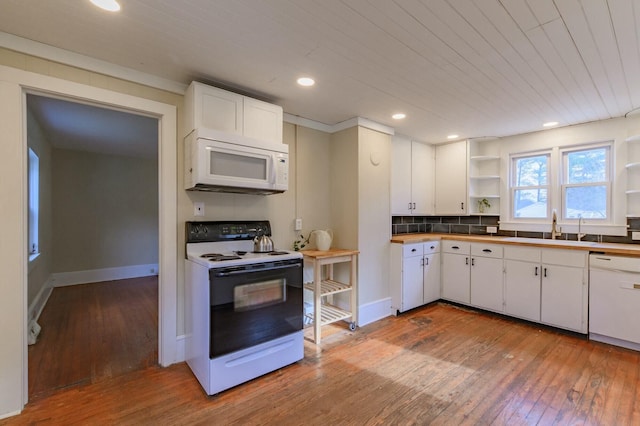 kitchen with white appliances, white cabinets, a sink, and open shelves