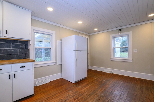 kitchen featuring visible vents, backsplash, dark wood-style floors, and freestanding refrigerator