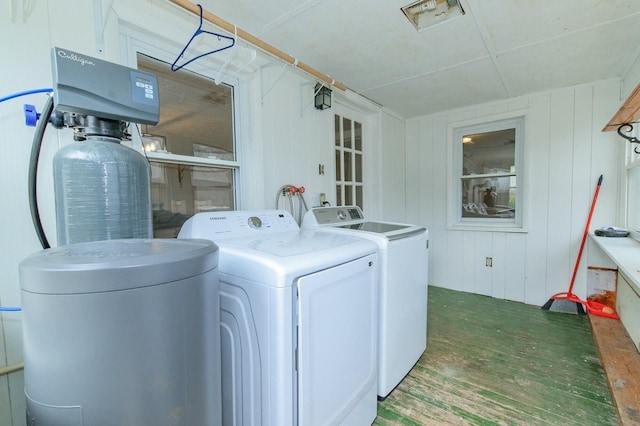 washroom featuring laundry area, washer and clothes dryer, and wood finished floors