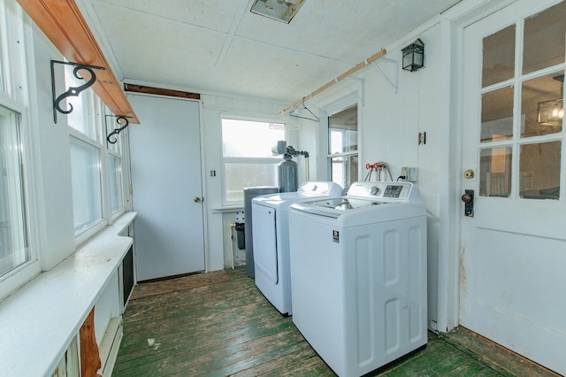 clothes washing area with laundry area, dark wood finished floors, and separate washer and dryer