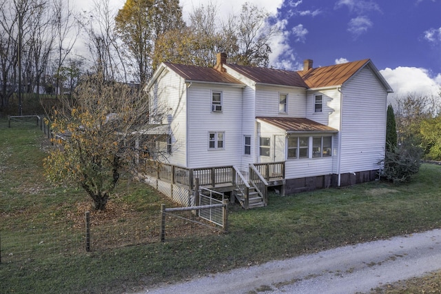 view of front of property featuring a chimney, a front yard, fence, a deck, and cooling unit