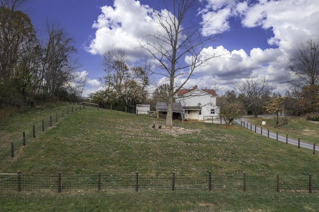 view of yard with a rural view and fence