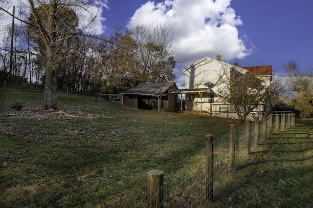 view of yard with an outbuilding, fence, and a wooden deck