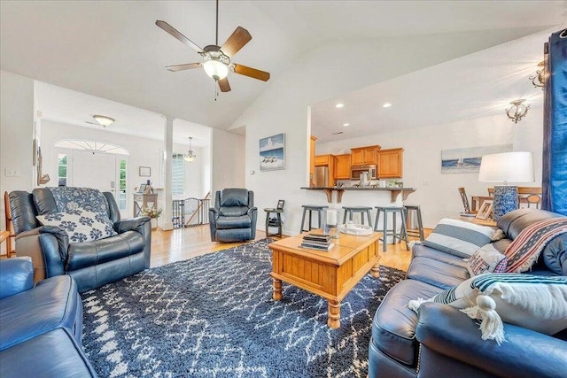 living room featuring ceiling fan, high vaulted ceiling, and light wood-style floors