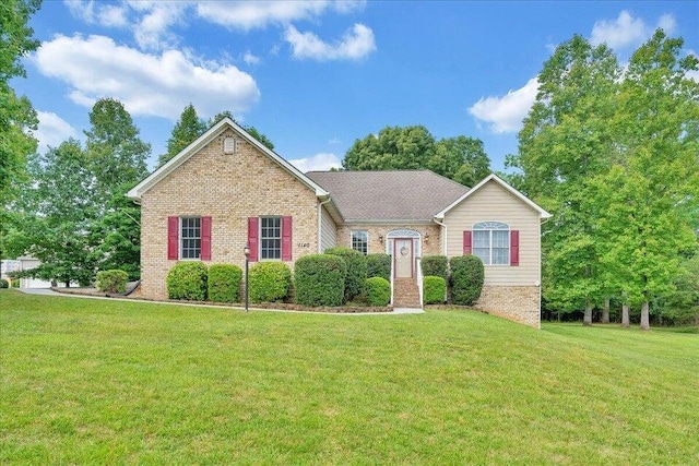 single story home featuring a front lawn and brick siding