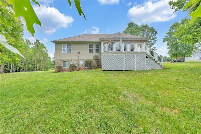 back of house with stairs, a lawn, and a wooden deck