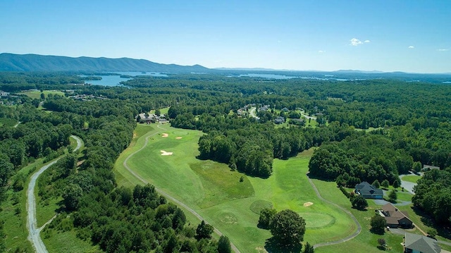 birds eye view of property featuring a mountain view and a wooded view