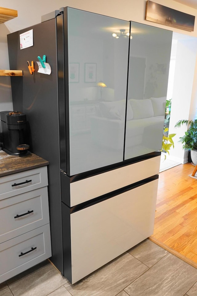 interior space with dark countertops, light wood-style flooring, and freestanding refrigerator