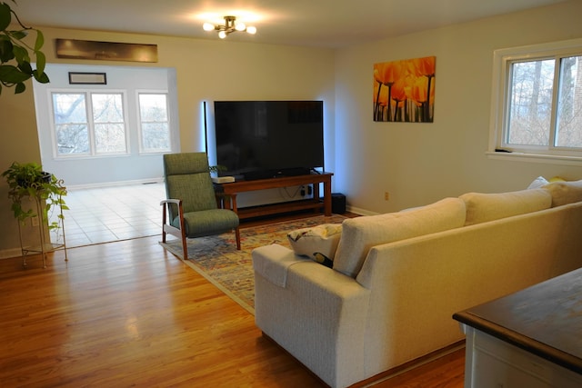 living area featuring baseboards and wood finished floors