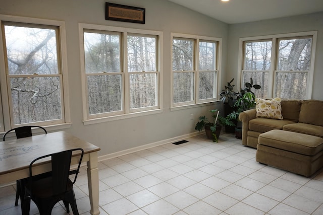 sunroom featuring vaulted ceiling, plenty of natural light, and visible vents