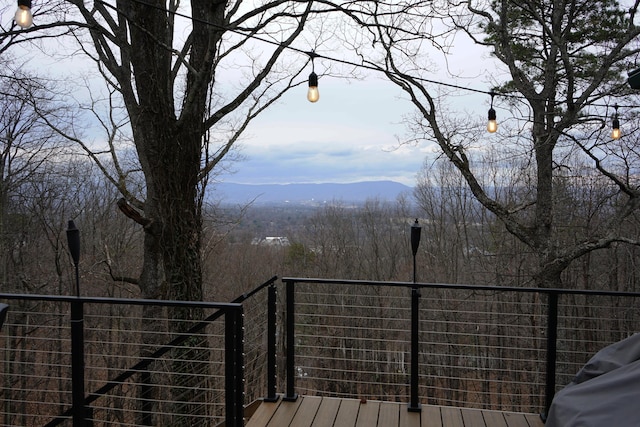 wooden deck with a view of trees