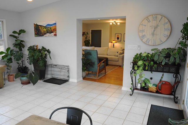 living room featuring light tile patterned floors and baseboards