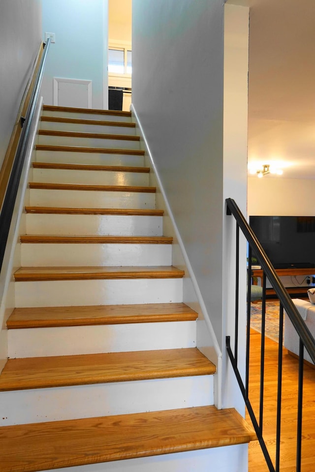 staircase with wood finished floors