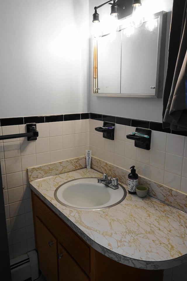 bathroom featuring a baseboard radiator, tile walls, and vanity