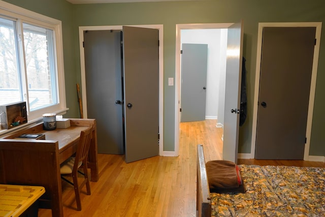 bedroom with baseboards, a closet, and light wood-style floors