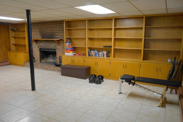 interior space featuring a fireplace, light tile patterned flooring, and built in features