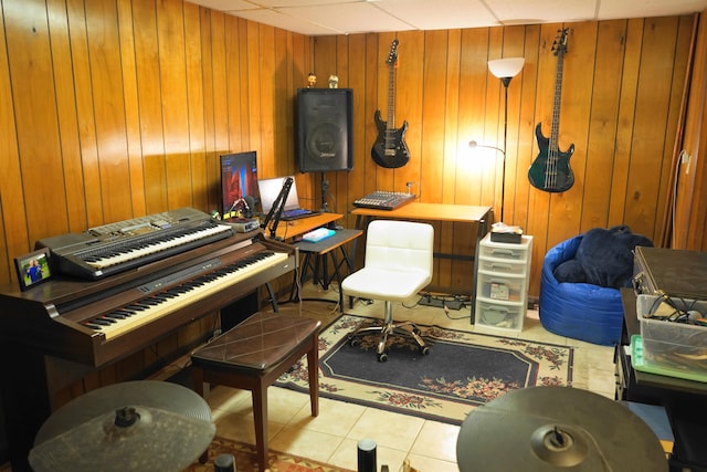 miscellaneous room with tile patterned flooring and wood walls