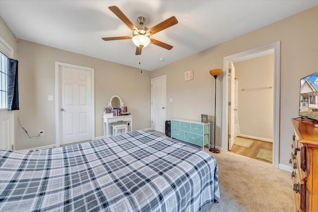 bedroom with a ceiling fan, carpet, and baseboards