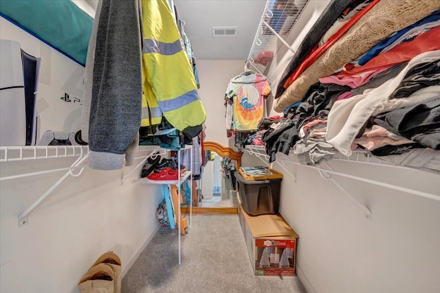 walk in closet featuring carpet and visible vents