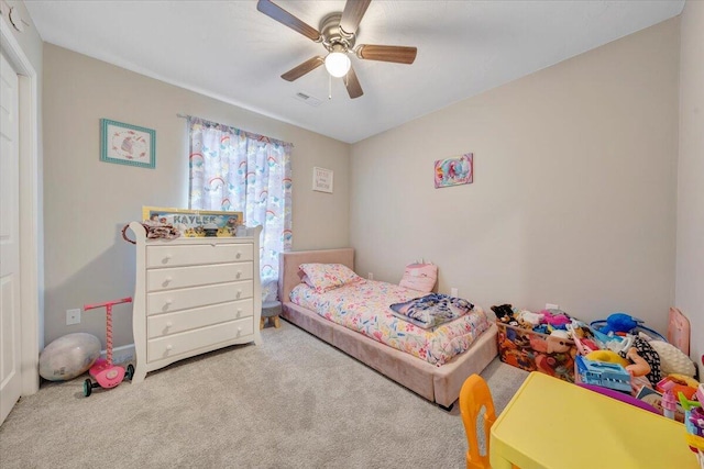 carpeted bedroom featuring ceiling fan and visible vents