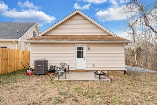 back of property featuring a yard, a patio, central AC unit, fence, and a fire pit