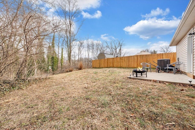 view of yard with an outdoor fire pit, cooling unit, a patio, and fence