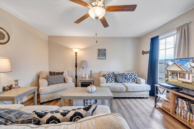 living area featuring ceiling fan and wood finished floors