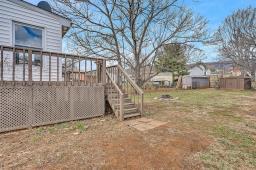 view of yard with a deck and stairway