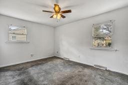 spare room featuring a ceiling fan and visible vents