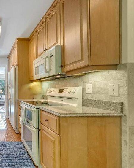 3370 Kelly Lane Ext, Roanoke, VA 24018 - kitchen featuring white appliances, light wood finished floors, backsplash, and light stone countertops