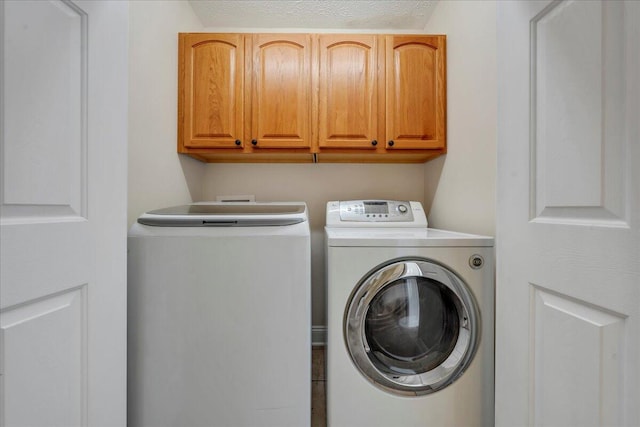 laundry room featuring washer and dryer and cabinet space