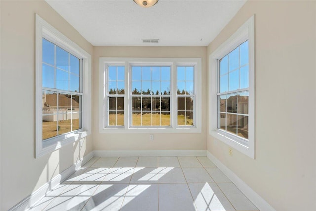 unfurnished sunroom featuring visible vents