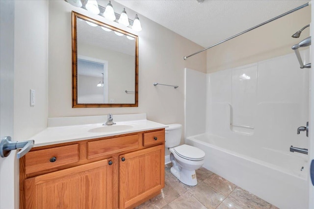 bathroom featuring toilet, vanity, a textured ceiling, and shower / bath combination